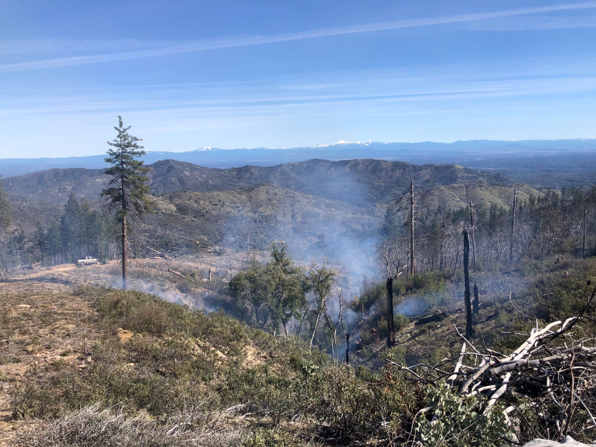 CAL FIRE grant-funded post-fire cleanup and hazardous-fuels reduction in progress across the Igo hillside.